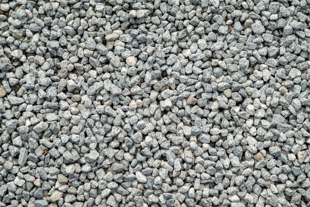 Detailed view of grey gravel stones creating a textured pattern for background use.